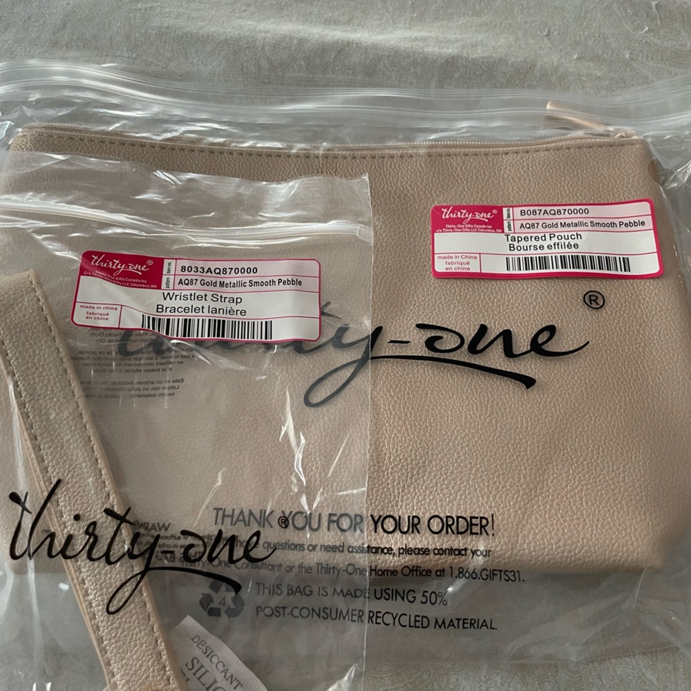 Brand new in bags 31 tapered pouch with wristlet in gold metallic.